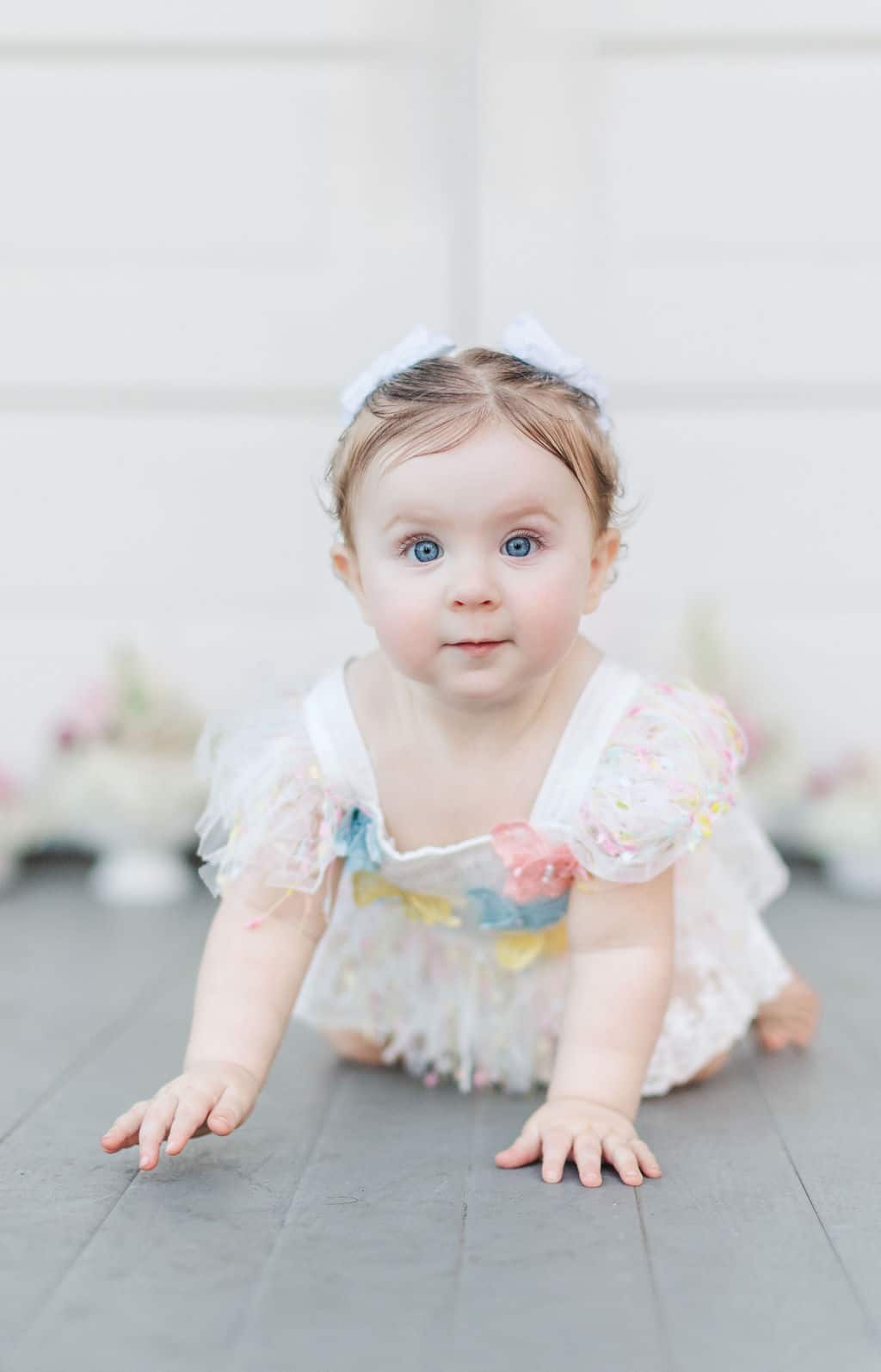 Baby celebrating their first birthday in front of Livingston Chapel in Mississippi, with a cake smash and family moments captured during the photoshoot.